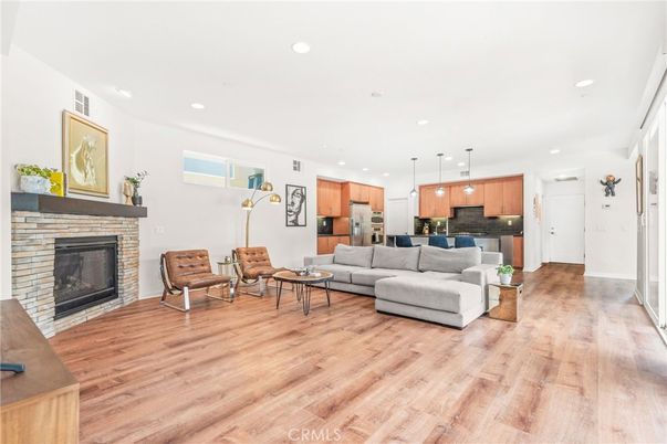 Fireplace, Interior, Kitchen, Living room, Pendant Lights, Recessed Lighting, Stainless Steel Appliances, Wood Texture Flooring