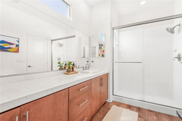 Bathroom, Dual Sink Vanities, Glass Shower, Interior, Recessed Lighting, Tile Countertops, Wood Texture Flooring