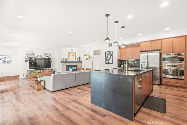 Fireplace, Interior, Kitchen, Living room, Pendant Lights, Recessed Lighting, Stainless Steel Appliances, Wood Texture Flooring