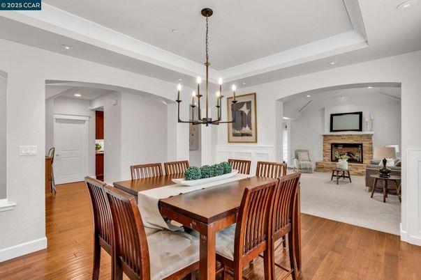 Chandelier, Dining room, Fireplace, Interior, Living room, Pendant Lights, Recessed Lighting, Wood Texture Flooring