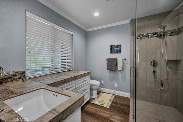 Bathroom, Glass Shower, Interior, Recessed Lighting, Tile Countertops, Wood Texture Flooring