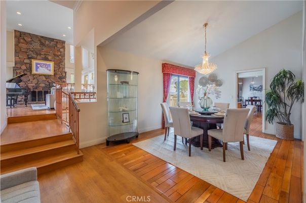 Chandelier, Dining room, Fireplace, Interior, Recessed Lighting, Stone Walls, Wood Texture Flooring