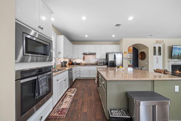 Fireplace, Interior, Kitchen, Recessed Lighting, Stainless Steel Appliances, Wood Texture Flooring