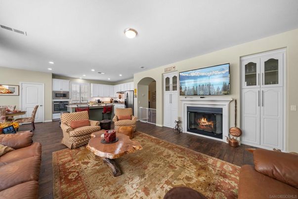 Dining room, Fireplace, Interior, Kitchen, Living room, Recessed Lighting, Stainless Steel Appliances, Wood Texture Flooring