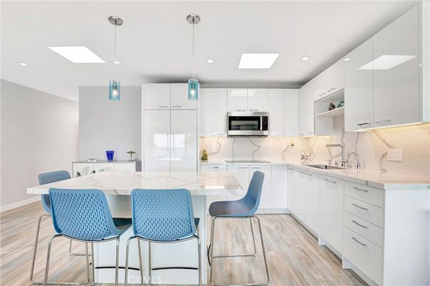 Interior, Kitchen, Marble Walls, Pendant Lights, Recessed Lighting, Stainless Steel Appliances, Wood Texture Flooring