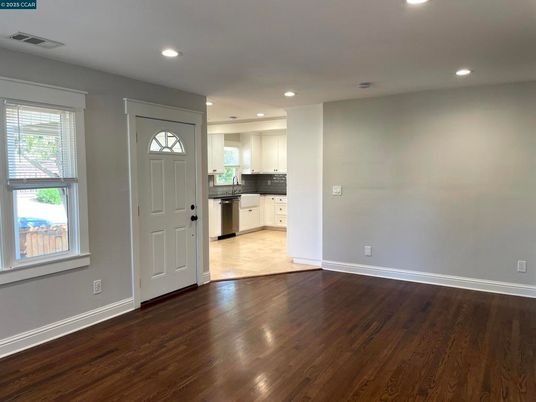 Empty room, Interior, Kitchen, Recessed Lighting, Stainless Steel Appliances, Wood Texture Flooring