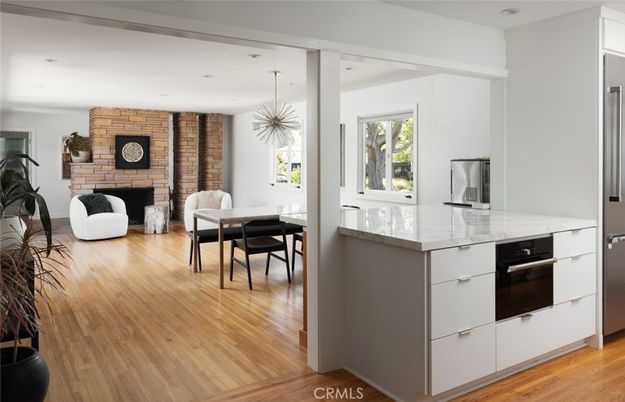Dining room, Fireplace, Interior, Kitchen, Pendant Lights, Recessed Lighting, Stainless Steel Appliances, Stone Walls, Wood Texture Flooring
