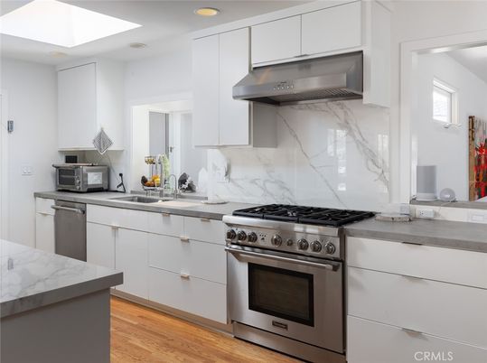 Interior, Kitchen, Marble Walls, Recessed Lighting, Stainless Steel Appliances, Wood Texture Flooring