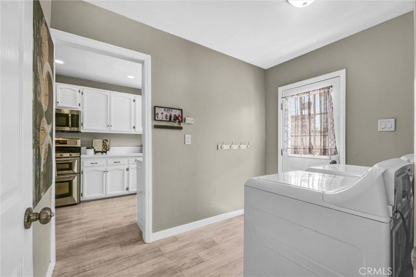Interior, Kitchen, Recessed Lighting, Washer, Wood Texture Flooring