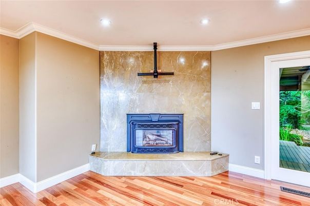 Fireplace, Interior, Marble Walls, Recessed Lighting, Wood Texture Flooring