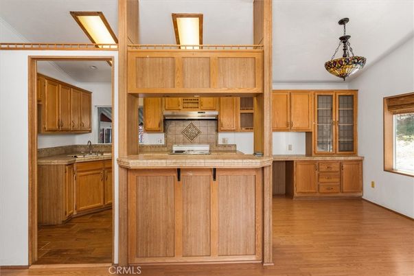 Interior, Kitchen, Pendant Lights, Tile Countertops, Wood Texture Flooring