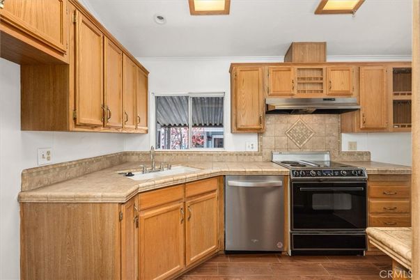 Interior, Kitchen, Recessed Lighting, Tile Countertops, Wood Texture Flooring