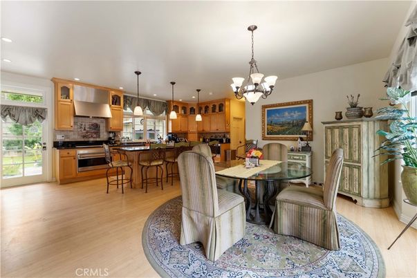 Chandelier, Dining room, Interior, Kitchen, Pendant Lights, Recessed Lighting, Stainless Steel Appliances, Wood Texture Flooring