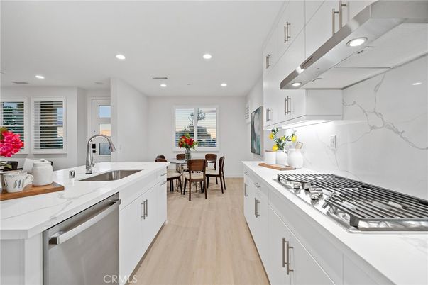 Dining room, Interior, Kitchen, Marble Walls, Recessed Lighting, Stainless Steel Appliances, Wood Texture Flooring