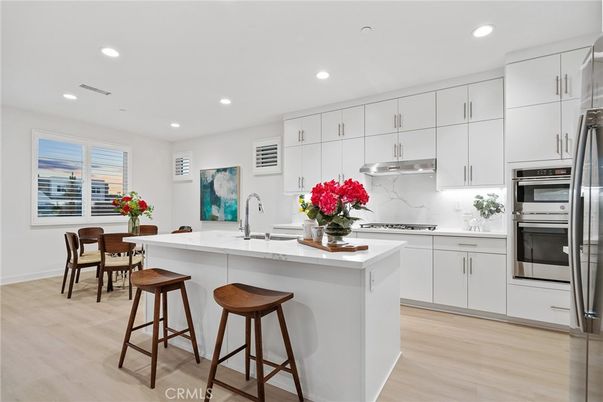 Dining room, Interior, Kitchen, Marble Walls, Recessed Lighting, Stainless Steel Appliances, Wood Texture Flooring