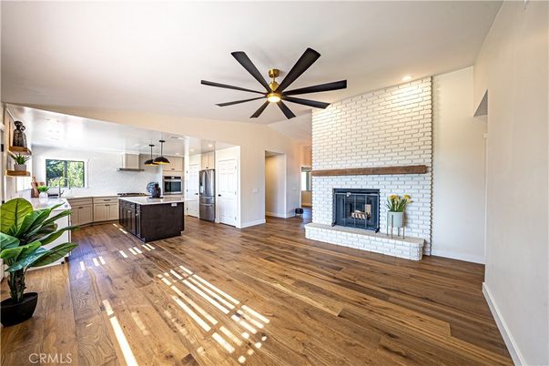 Fireplace, Interior, Kitchen, Recessed Lighting, Stainless Steel Appliances, Stone Walls, Wood Texture Flooring