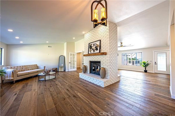 Fireplace, Interior, Living room, Recessed Lighting, Stone Walls, Wood Texture Flooring