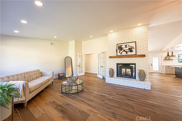 Fireplace, Interior, Living room, Recessed Lighting, Stone Walls, Wood Texture Flooring