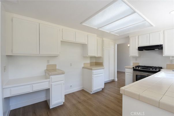 Interior, Kitchen, Recessed Lighting, Tile Countertops, Wood Texture Flooring