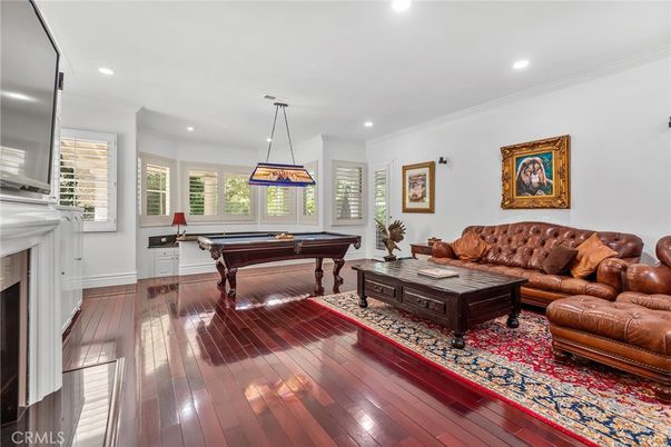 Billiard Table, Fireplace, Game Room, Interior, Living room, Pendant Lights, Recessed Lighting, Wood Texture Flooring
