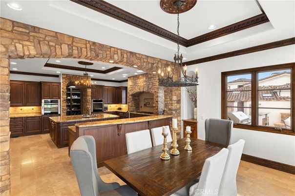 Chandelier, Dining room, Fireplace, Interior, Kitchen, Pendant Lights, Recessed Lighting, Stainless Steel Appliances, Stone Walls