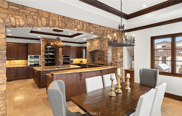 Chandelier, Dining room, Interior, Kitchen, Pendant Lights, Recessed Lighting, Stainless Steel Appliances, Stone Walls