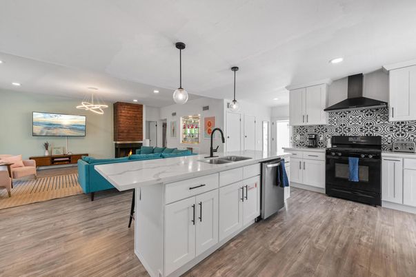 Fireplace, Interior, Kitchen, Living room, Pendant Lights, Recessed Lighting, Stainless Steel Appliances, Wood Texture Flooring