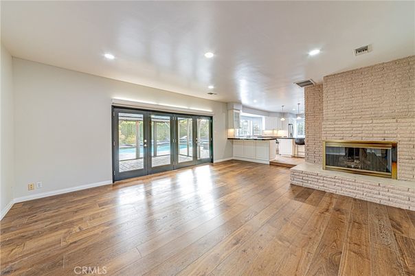 Empty room, Fireplace, Interior, Kitchen, Pendant Lights, Recessed Lighting, Stone Walls, Wood Texture Flooring