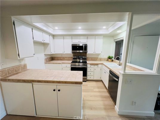 Interior, Kitchen, Recessed Lighting, Stainless Steel Appliances, Tile Countertops, Wood Texture Flooring