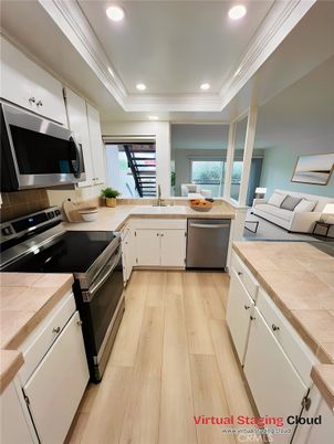 Interior, Kitchen, Recessed Lighting, Stainless Steel Appliances, Tile Countertops, Wood Texture Flooring
