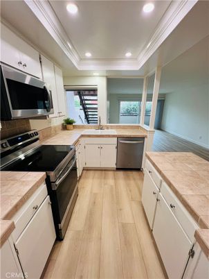 Interior, Kitchen, Recessed Lighting, Stainless Steel Appliances, Tile Countertops, Wood Texture Flooring