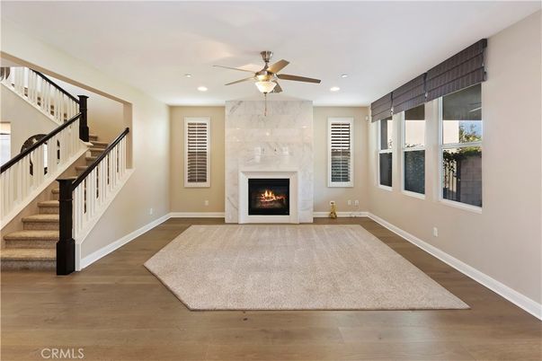 Fireplace, Interior, Marble Walls, Recessed Lighting, Wood Texture Flooring
