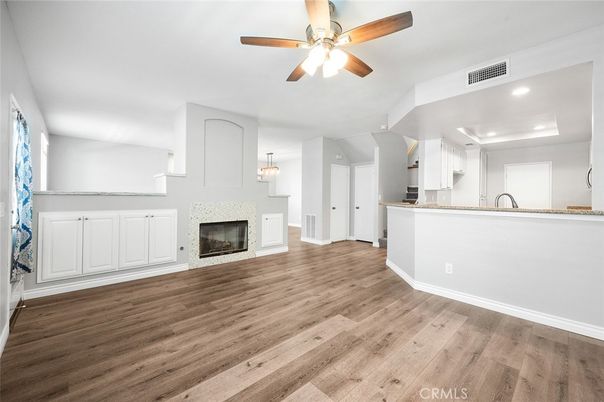 Empty room, Fireplace, Interior, Kitchen, Pendant Lights, Recessed Lighting, Wood Texture Flooring