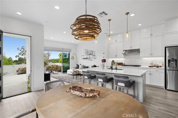 Chandelier, Dining room, Interior, Kitchen, Living room, Pendant Lights, Recessed Lighting, Stainless Steel Appliances, Wood Texture Flooring