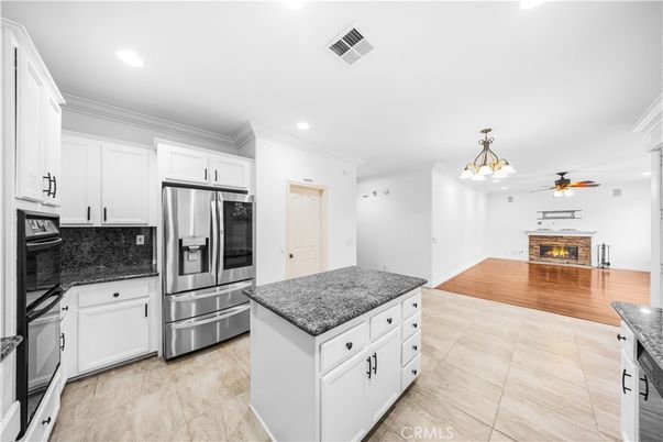 Fireplace, Interior, Kitchen, Recessed Lighting, Stainless Steel Appliances, Wood Texture Flooring