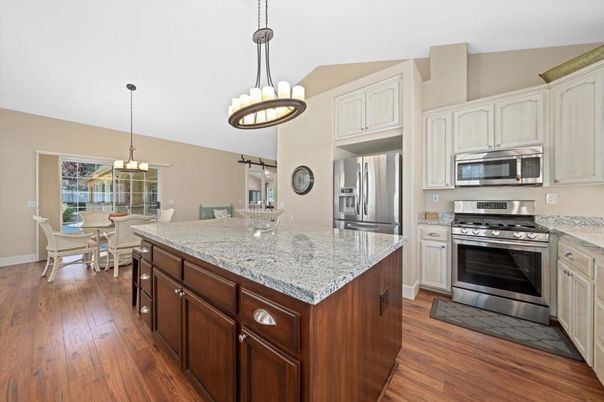 Chandelier, Dining room, Interior, Kitchen, Pendant Lights, Stainless Steel Appliances, Wood Texture Flooring