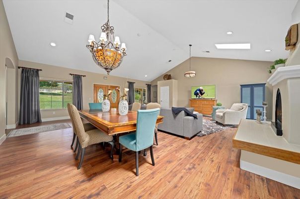 Chandelier, Dining room, Fireplace, Interior, Living room, Pendant Lights, Recessed Lighting, Wood Texture Flooring
