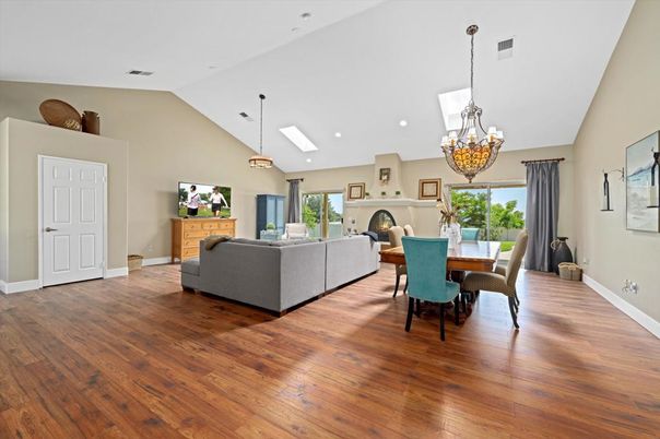 Chandelier, Dining room, Fireplace, Interior, Living room, Pendant Lights, Recessed Lighting, Wood Texture Flooring