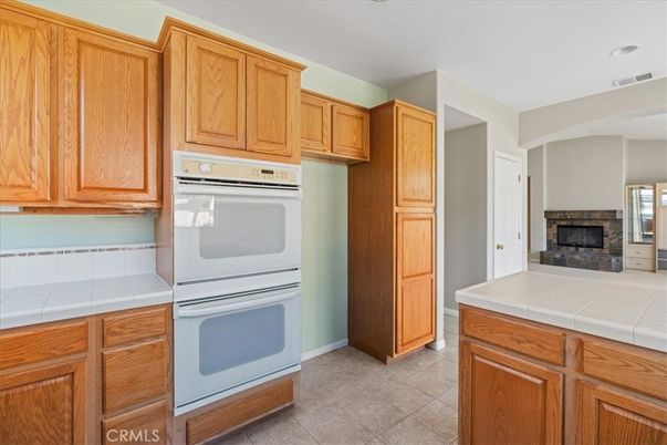 Fireplace, Interior, Kitchen, Recessed Lighting, Tile Countertops