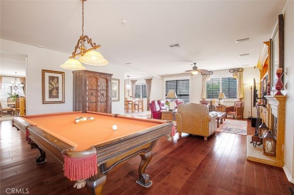 Billiard Table, Chandelier, Fireplace, Game Room, Interior, Living room, Pendant Lights, Wood Texture Flooring