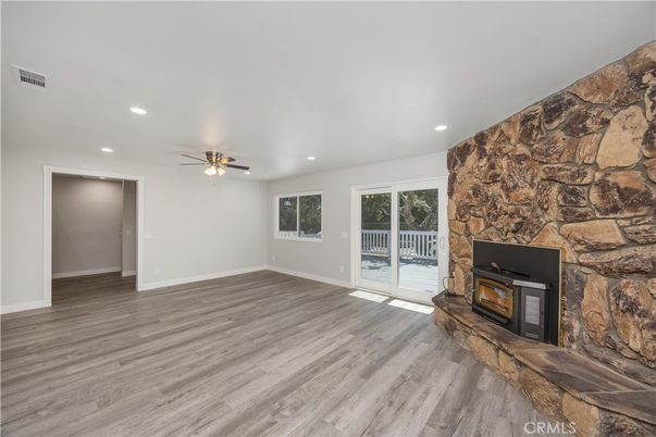 Empty room, Fireplace, Interior, Recessed Lighting, Stone Walls, Wood Texture Flooring