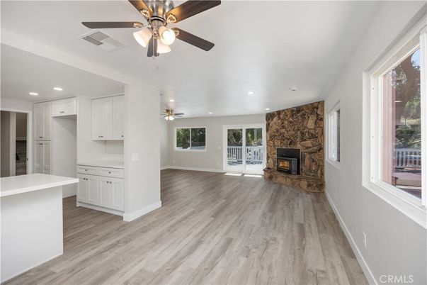 Empty room, Fireplace, Interior, Kitchen, Recessed Lighting, Stone Walls, Wood Texture Flooring