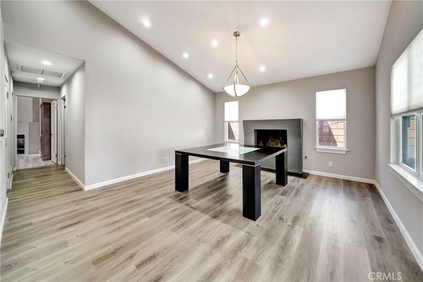 Fireplace, Game Room, Interior, Pendant Lights, Recessed Lighting, Wood Texture Flooring