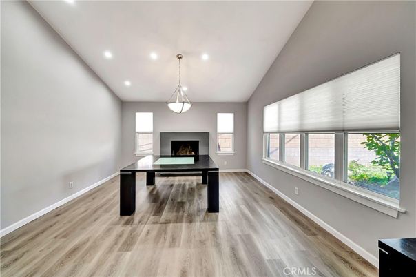 Fireplace, Game Room, Interior, Pendant Lights, Recessed Lighting, Wood Texture Flooring