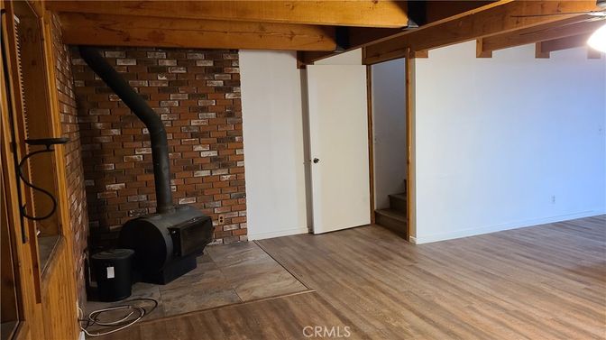 Empty room, Fireplace, Interior, Stone Walls, Wooden Beams, Wood Texture Flooring