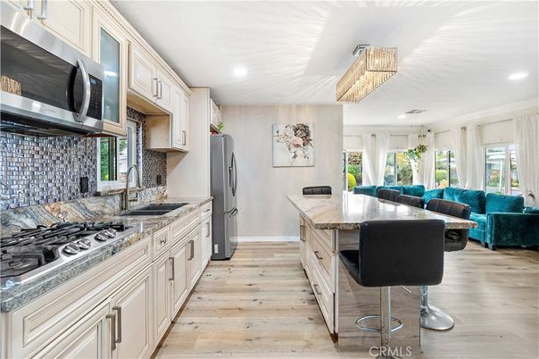 Chandelier, Interior, Kitchen, Living room, Recessed Lighting, Stainless Steel Appliances, Wood Texture Flooring