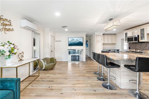 Chandelier, Fireplace, Interior, Kitchen, Recessed Lighting, Stainless Steel Appliances, Wood Texture Flooring