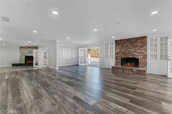 Empty room, Fireplace, Interior, Recessed Lighting, Stone Walls, Wood Texture Flooring