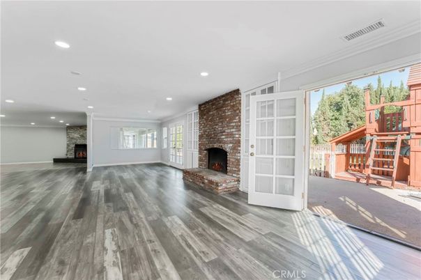 Empty room, Fireplace, Interior, Recessed Lighting, Stone Walls, Wood Texture Flooring