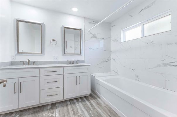 Bathroom, Dual Sink Vanities, Interior, Marble Walls, Recessed Lighting, Wood Texture Flooring
